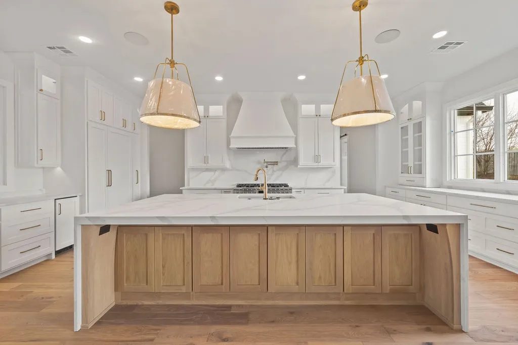 Refinished white perimeter cabinetry with natural wood island