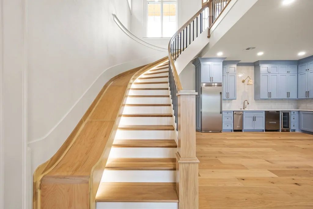 Hand-stained staircase and handrail showcasing natural wood grain